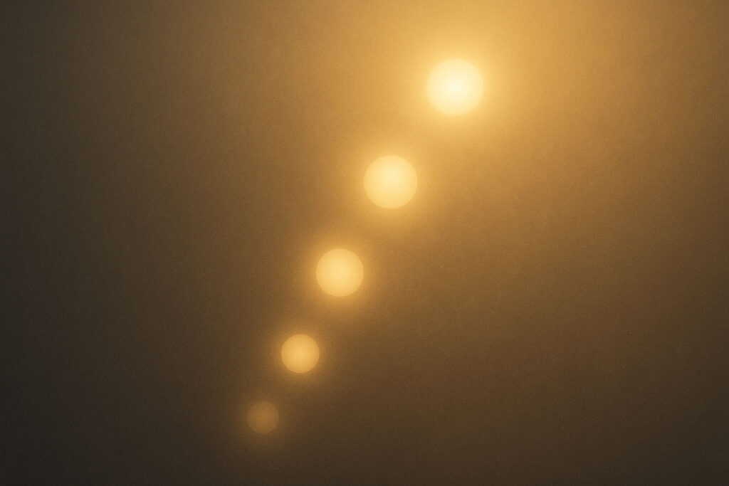 Abstract glowing spheres rising upward, symbolizing higher emotional vibrations