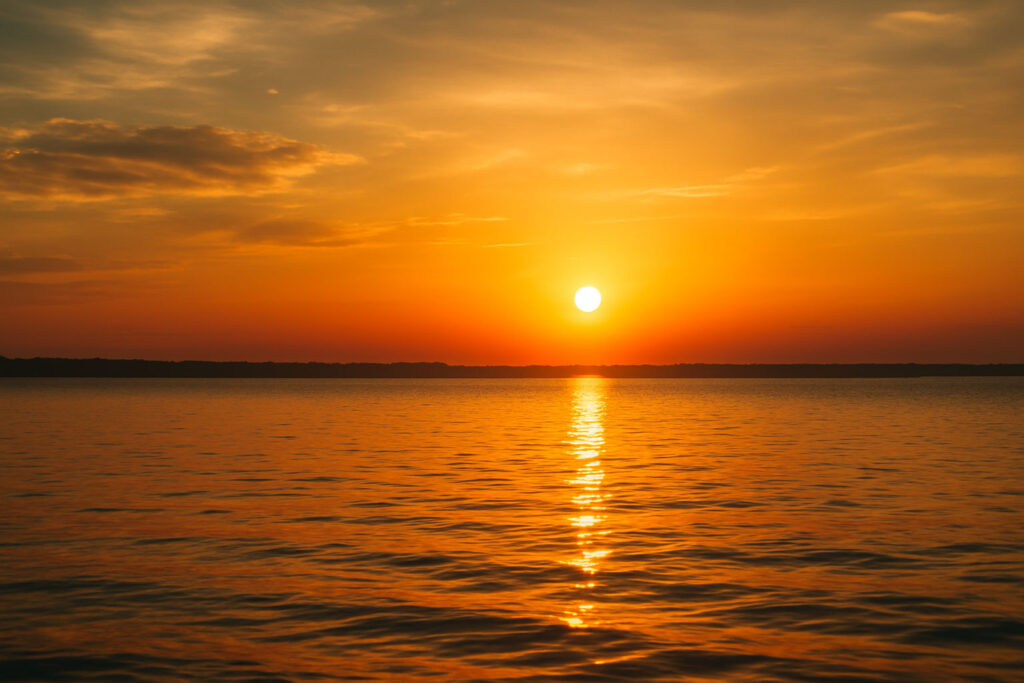 Sunset view over calm water, symbolizing gratitude and peaceful reflection
